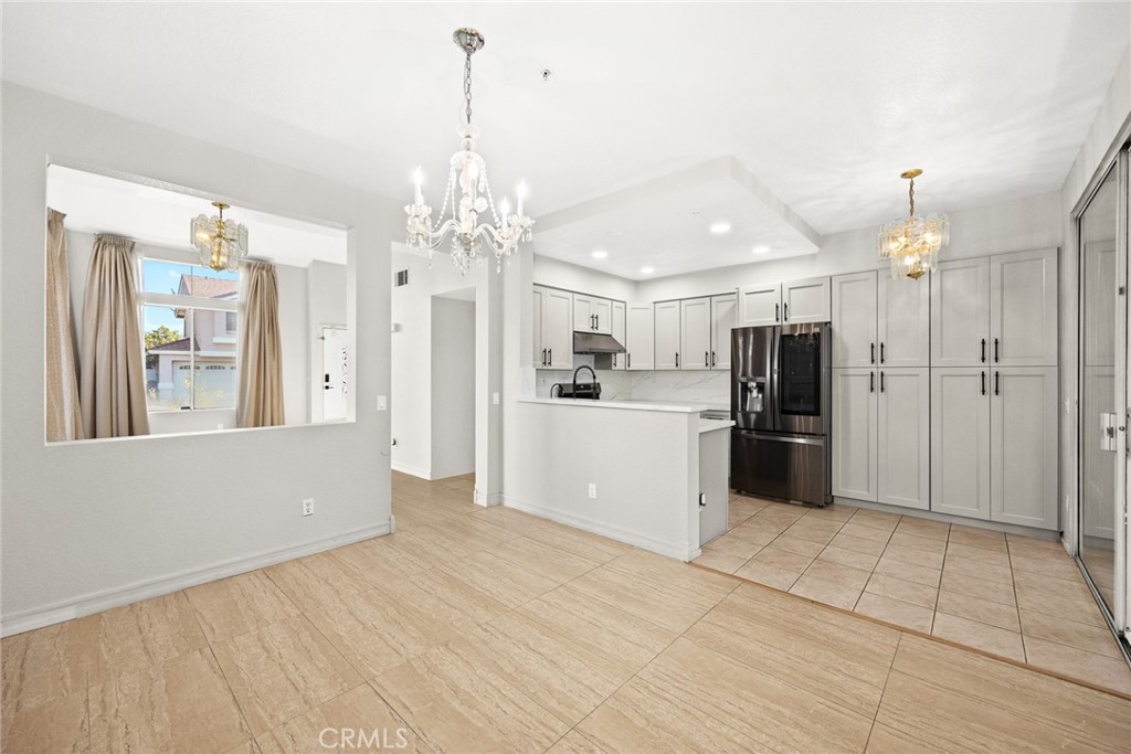 7190 Trivento Place Rancho Cucamonga, CA 91701 - Photo 4 of 13 a view of a kitchen with a sink and a refrigerator