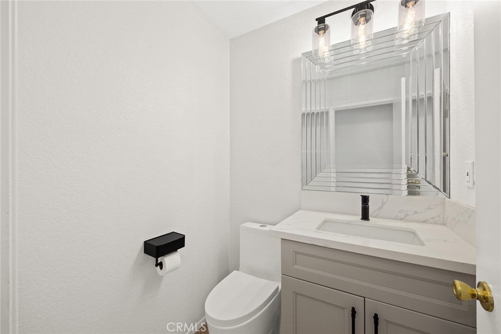 7190 Trivento Place Rancho Cucamonga, CA 91701 - Photo 7 of 13 a bathroom with a sink a toilet and mirror