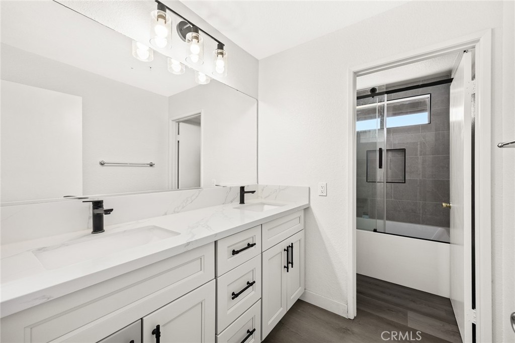7190 Trivento Place Rancho Cucamonga, CA 91701 - Photo 10 of 13 a bathroom with a double vanity sink mirror and shower