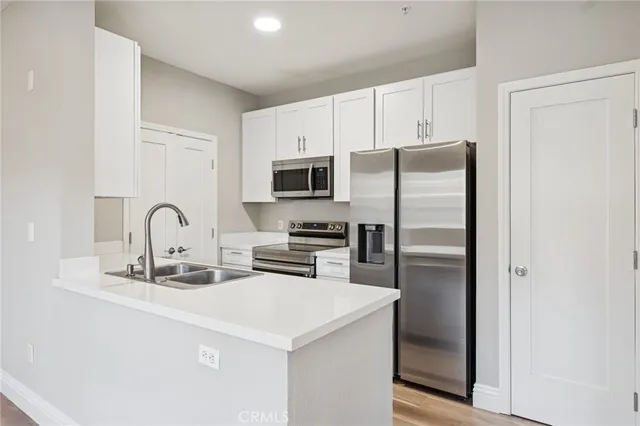 a kitchen with a refrigerator and a sink