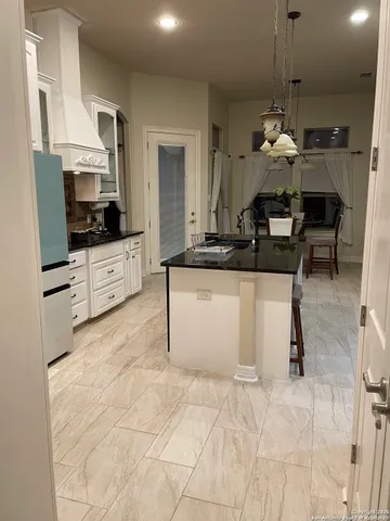 a kitchen with stainless steel appliances kitchen island granite countertop a sink and cabinets