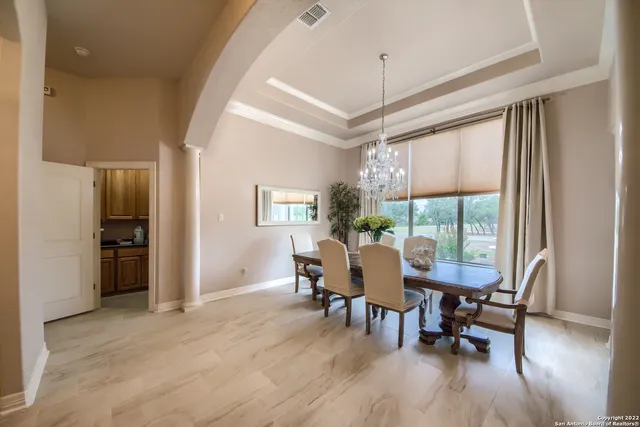 a dining room with furniture window and wooden floor