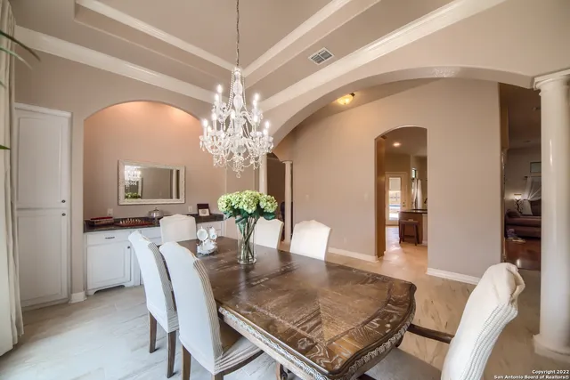 a view of a dining room with furniture and chandelier