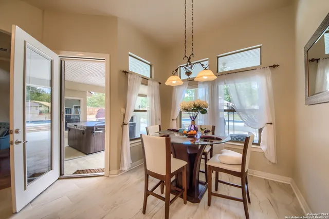 a dining room with furniture and a chandelier