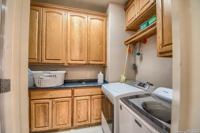 a view of a kitchen with a sink and cabinets