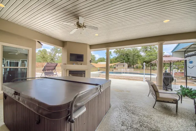 a large kitchen with kitchen island a large window in it