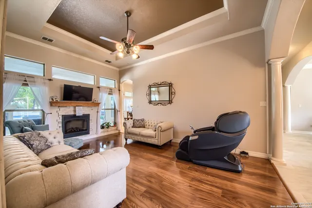 a living room with furniture a fireplace and a flat screen tv