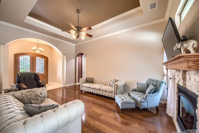 a living room with furniture and a chandelier