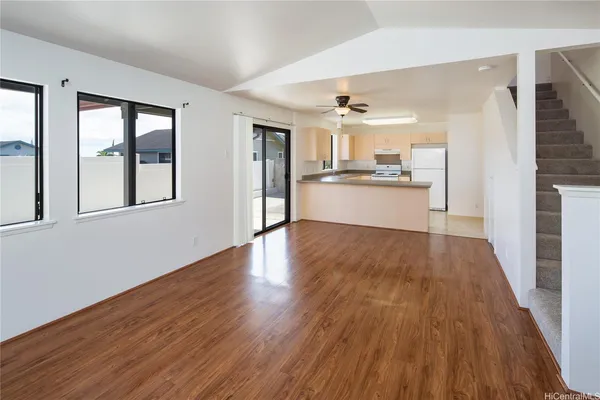 a view of a kitchen with wooden floor and windows