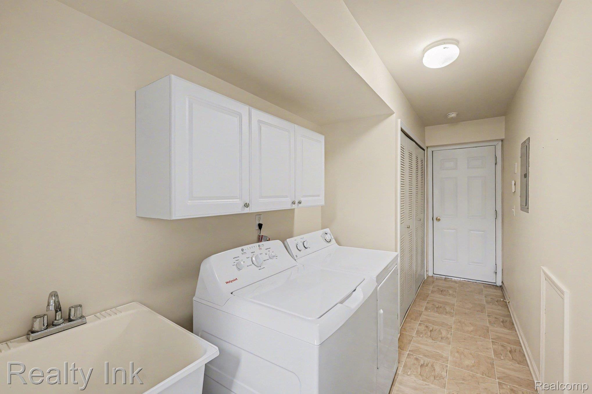 3399 Tremonte Circle Rochester, MI 48306 - Photo 9 of 14 Laundry room featuring independent washer and dryer and cabinet space