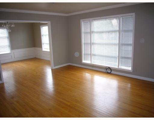 633 Sorrell Street Corpus Christi, TX 78404 - Photo 3 of 6 an empty room with wooden floor and windows
