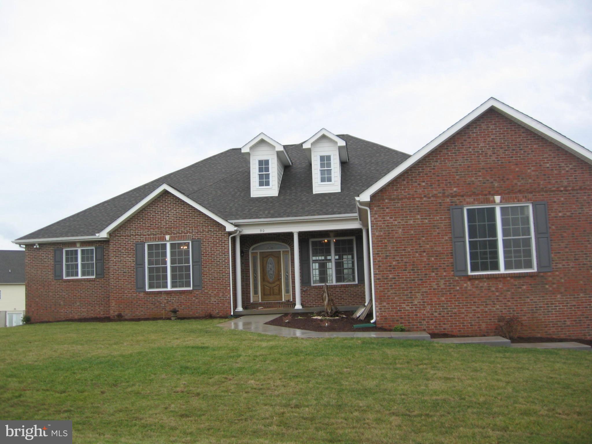 90 Reprisal Road Inwood, WV 25428 - Photo 3 of 6 a front view of a house with a garden