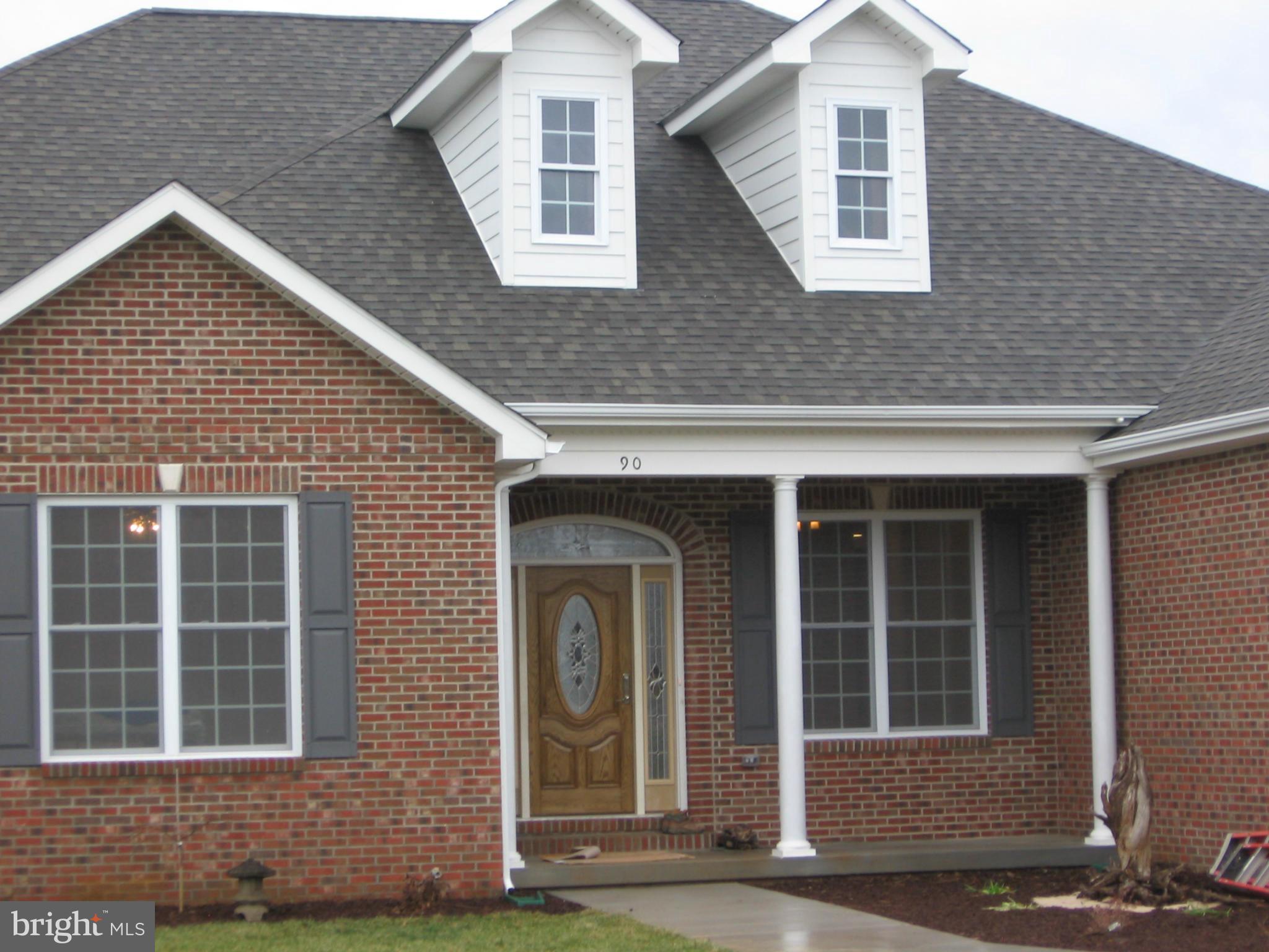 90 Reprisal Road Inwood, WV 25428 - Photo 4 of 6 a front view of a house with a yard