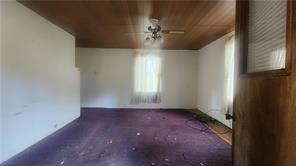 140 High Street Avonmore, PA 15618 - Photo 7 of 19 en empty room with windows and chandelier fan