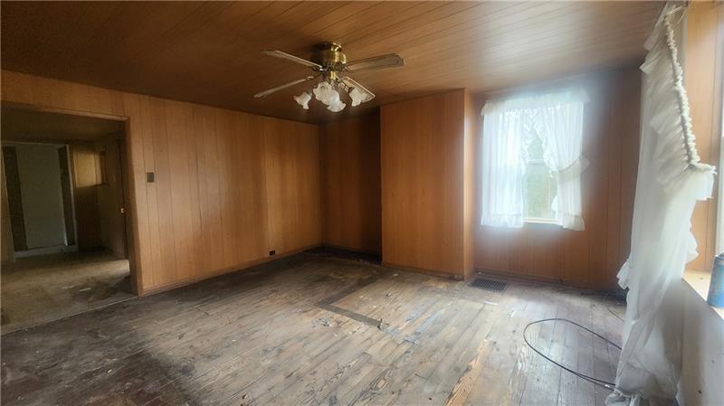 140 High Street Avonmore, PA 15618 - Photo 10 of 19 an empty room with windows and chandelier fan
