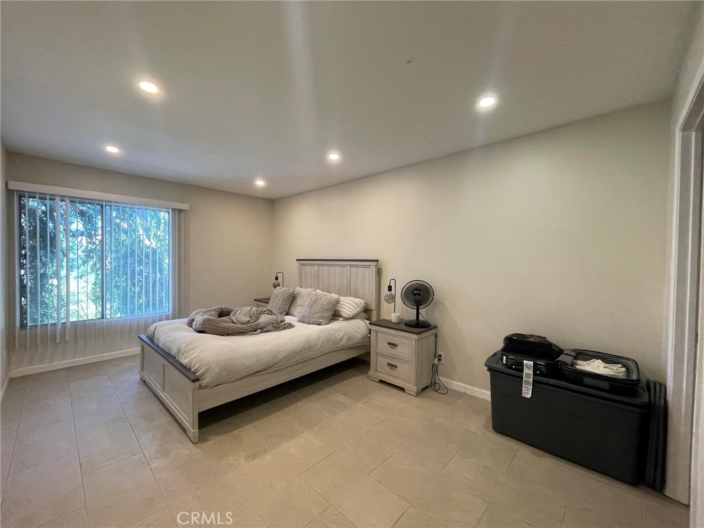 5700 Etiwanda Avenue, Unit 240 Los Angeles, CA 91356 - Photo 22 of 39 a spacious bedroom with a bed and a couch