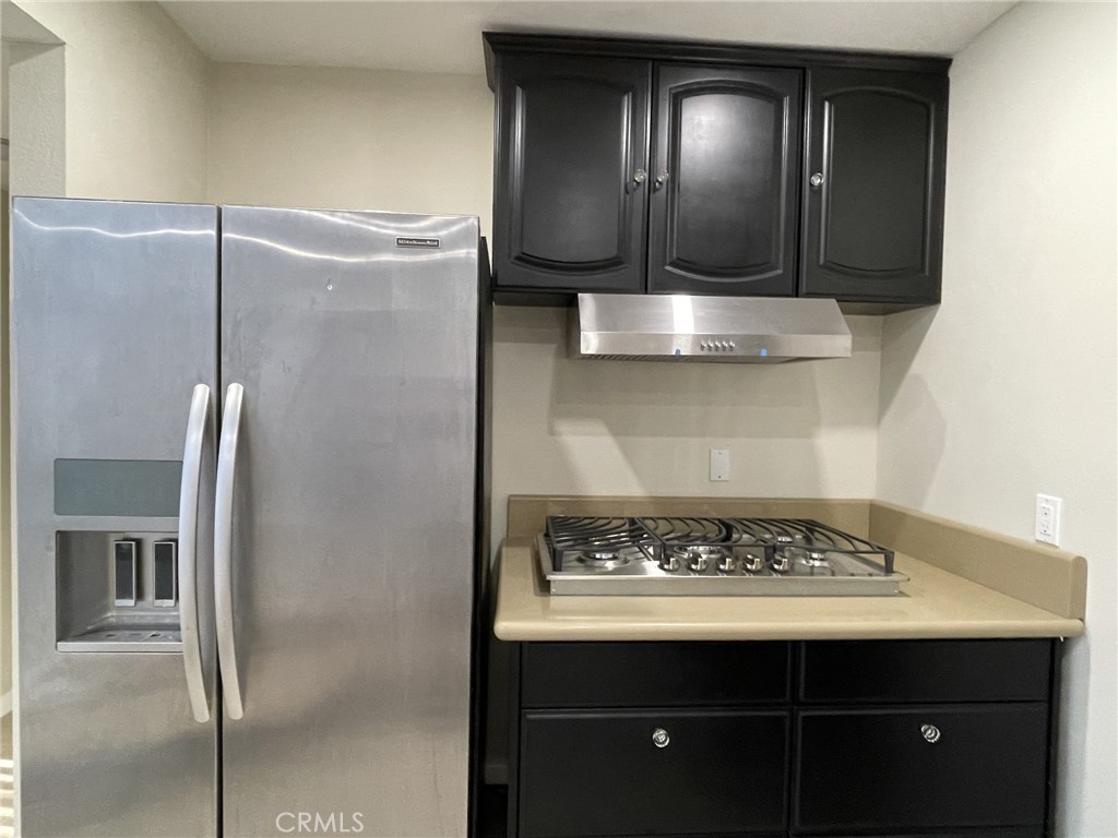 5700 Etiwanda Avenue, Unit 240 Los Angeles, CA 91356 - Photo 3 of 39 a view of kitchen island with wooden floor