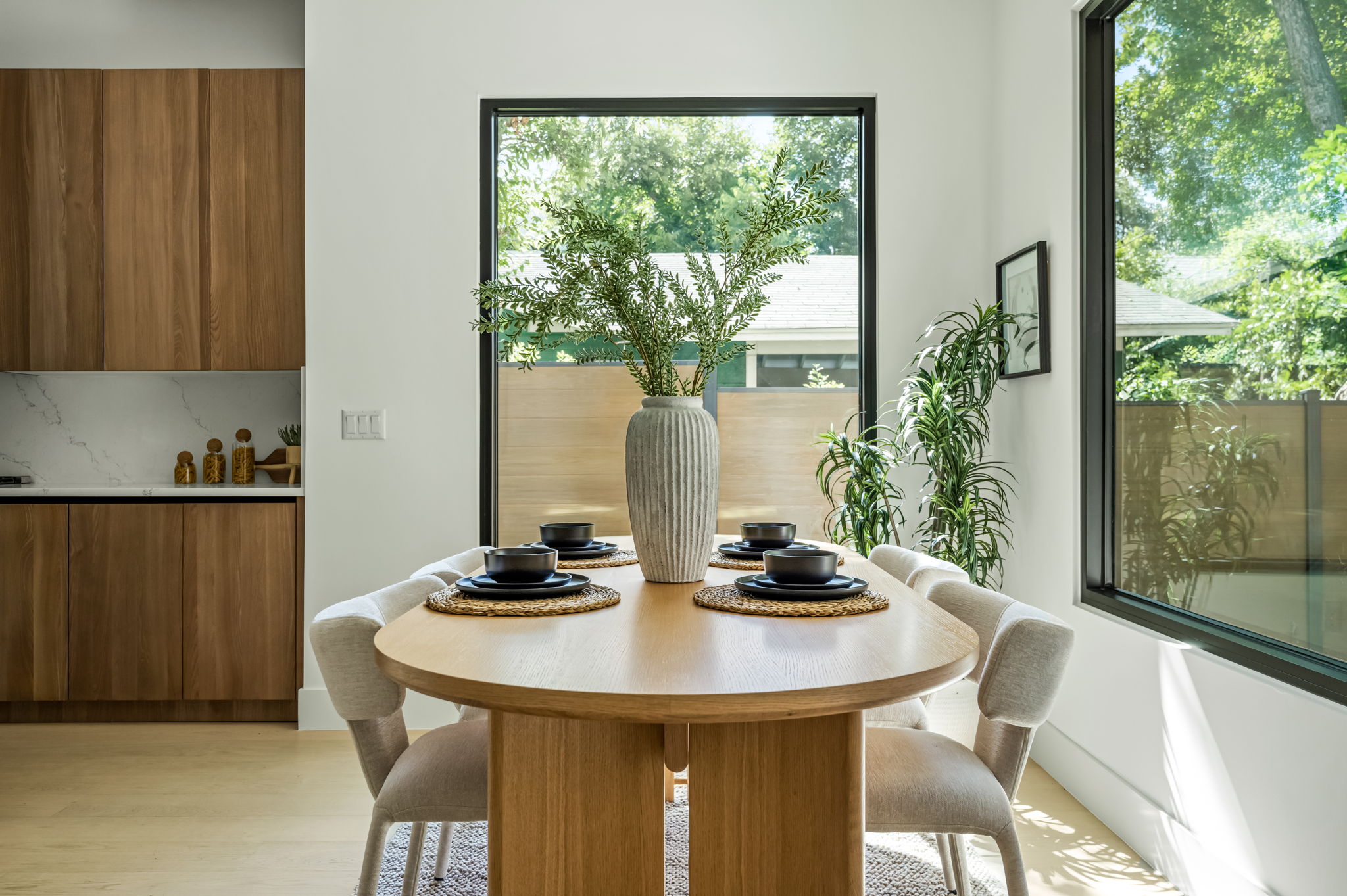 3210 Thompson Street Austin, TX 78702 - Photo 39 of 39 A chic dining area flows into a sleek kitchen, showcasing a seamless open floor plan.
