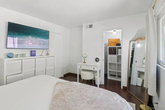 a bedroom with a bed and a flat screen tv