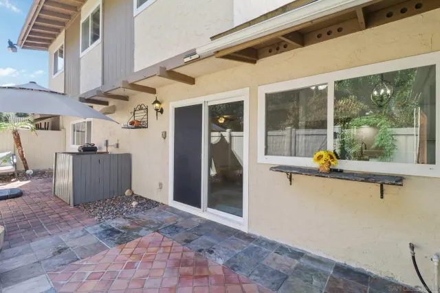 a view of a patio with furniture and a backyard