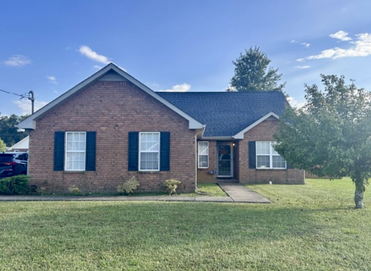 a front view of house with yard and green space