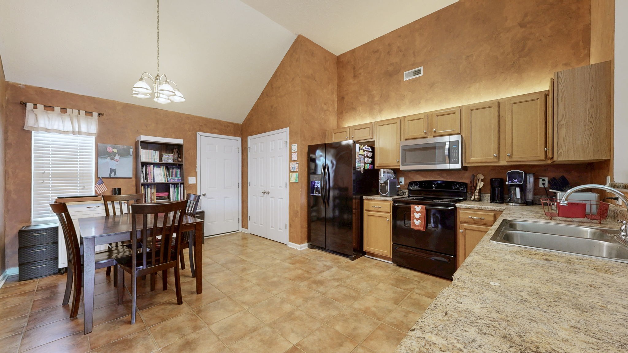 2822 Ridgewood Drive Christiana, TN 37037 - Photo 6 of 39 a kitchen with stainless steel appliances granite countertop a stove a refrigerator a kitchen island a table and chairs