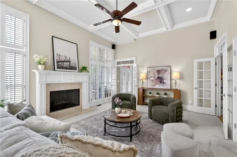a living room with furniture a fireplace and a large window