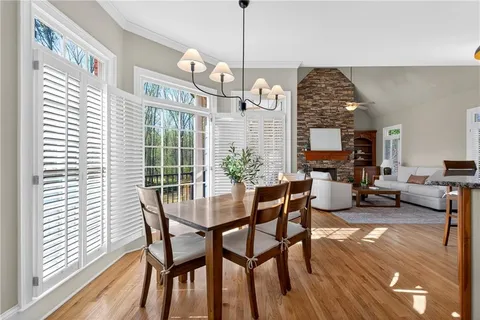a kitchen with granite countertop wooden cabinets and dining table