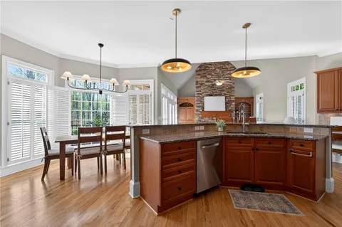 a kitchen with wooden cabinets and a stove top oven