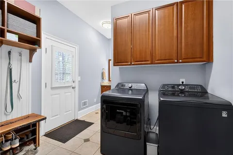 a spacious bathroom with a double vanity sink a mirror and a bathtub