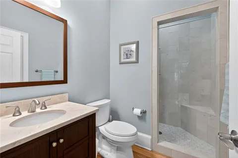 a bathroom with a sink vanity granite and a mirror
