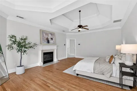 a spacious bedroom with a bed a couch and a large window