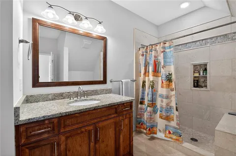 a kitchen with kitchen island a counter top space cabinets and stainless steel appliances
