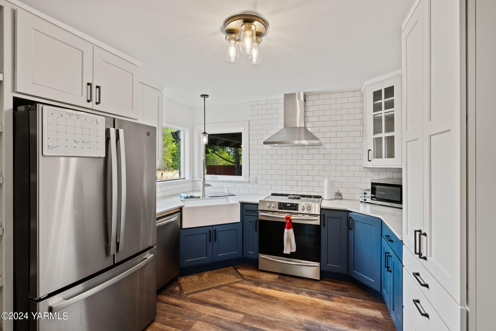 30 Craig Road Naches, WA 98937 - Photo 8 of 21 a kitchen with stainless steel appliances granite countertop a refrigerator a sink dishwasher a stove and white countertops with wooden floor