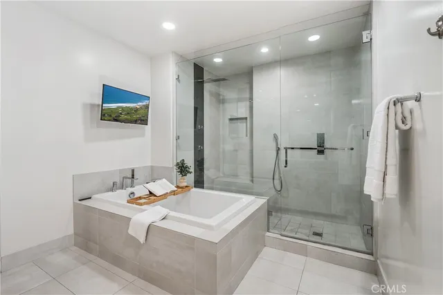 a bathroom with a bathtub and a shower