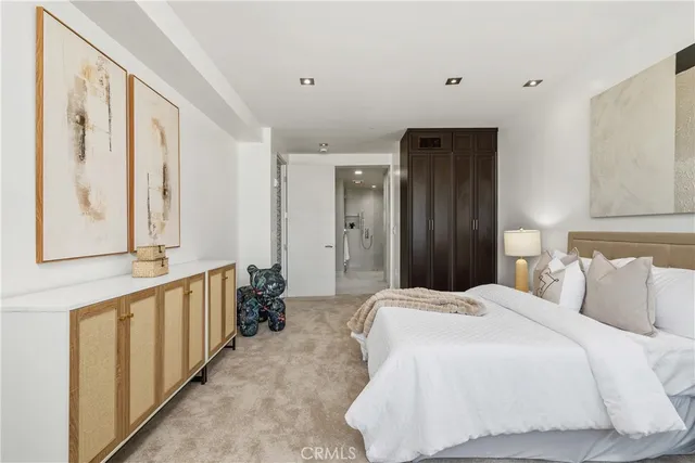 a bedroom with a large bed and a large window