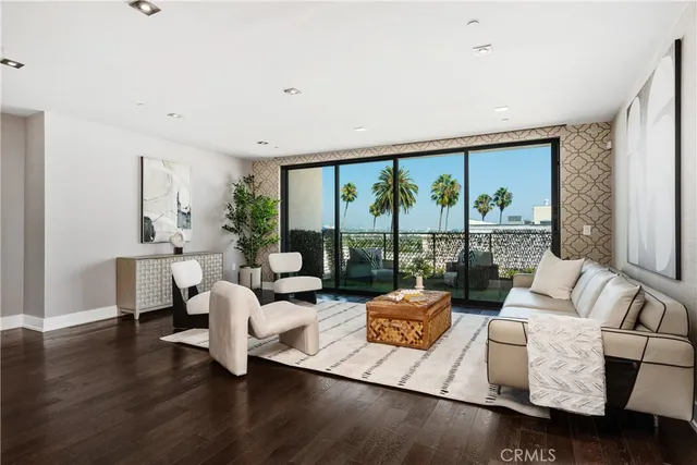 a living room with fireplace furniture and a large window