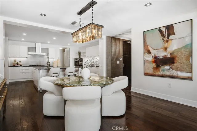 a dining room with furniture and a large window