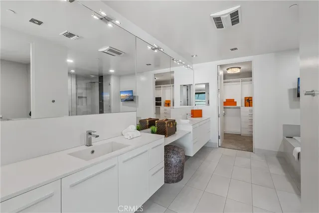 a large white room with lot of white cabinets