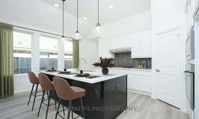 a dining table with chairs and window