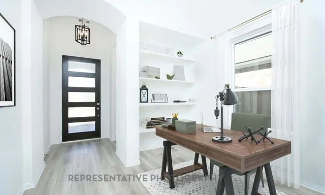 a view of a workspace with furniture and wooden floor