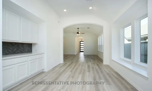 a view of hallway with wooden floor
