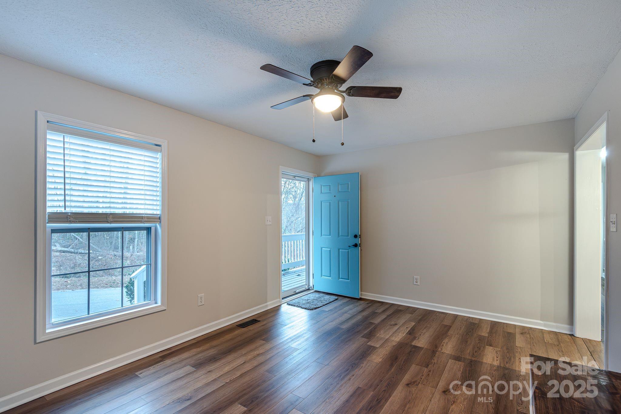263 Newberry Drive Fletcher, NC 28732 - Photo 16 of 29 a view of empty room with wooden floor and fan