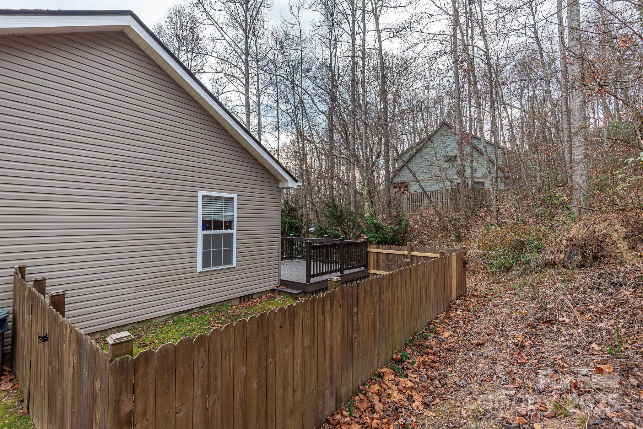 263 Newberry Drive Fletcher, NC 28732 - Photo 17 of 29 a view of a house with a wooden fence