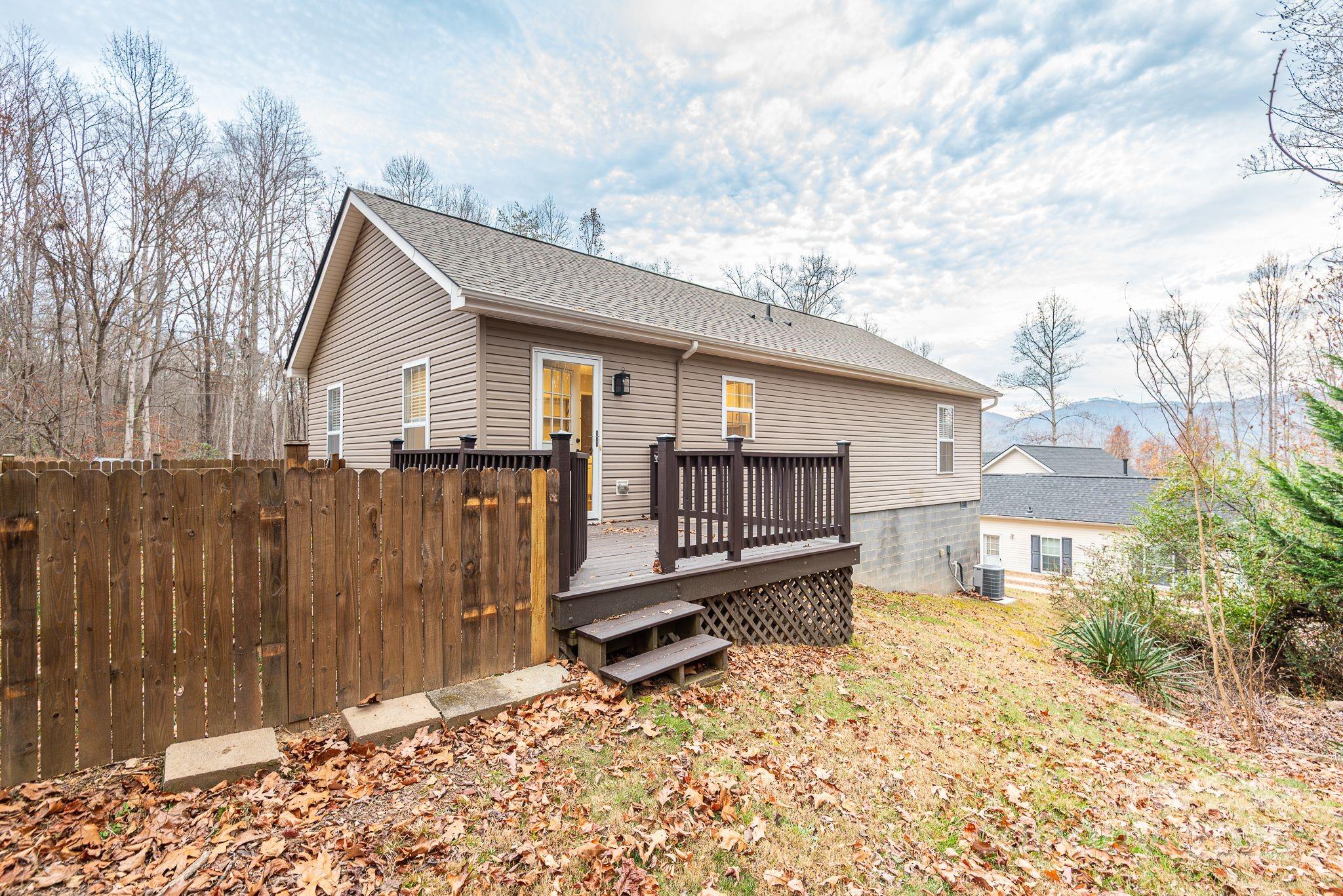 263 Newberry Drive Fletcher, NC 28732 - Photo 19 of 29 a backyard of a house with wooden fence and trees
