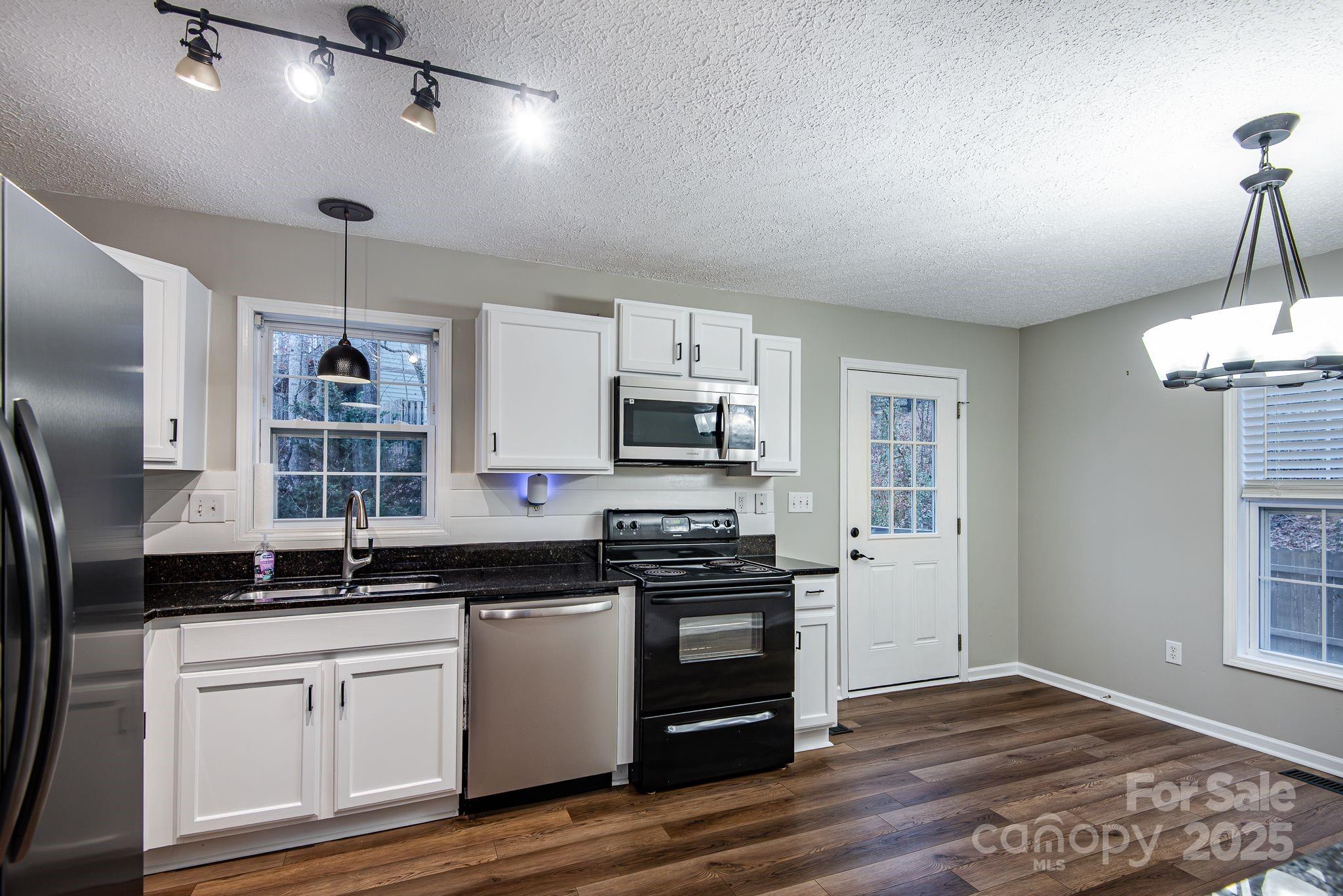 263 Newberry Drive Fletcher, NC 28732 - Photo 20 of 29 a kitchen with stainless steel appliances granite countertop a stove and a refrigerator
