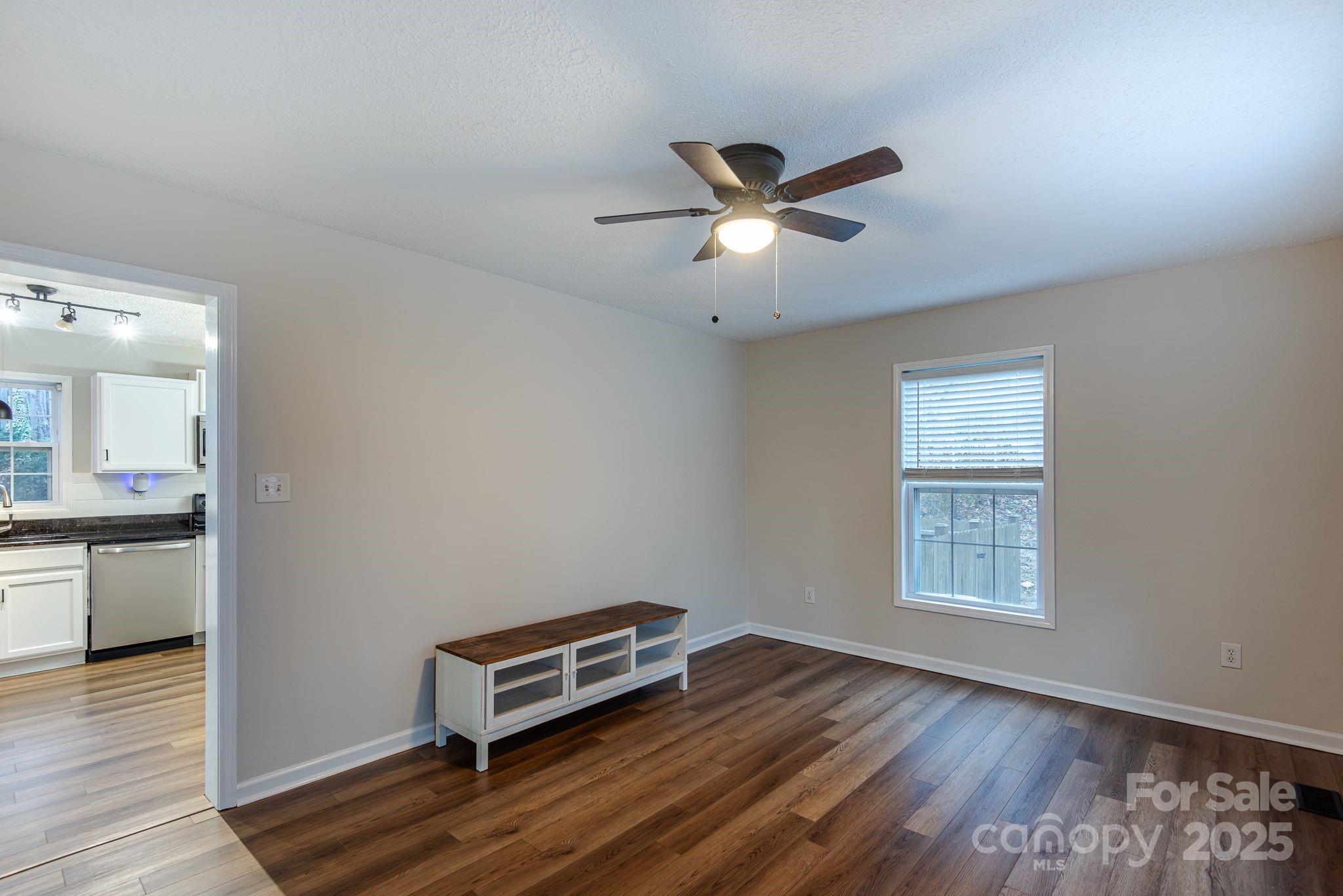 263 Newberry Drive Fletcher, NC 28732 - Photo 22 of 29 a living room with a wooden floor and a window