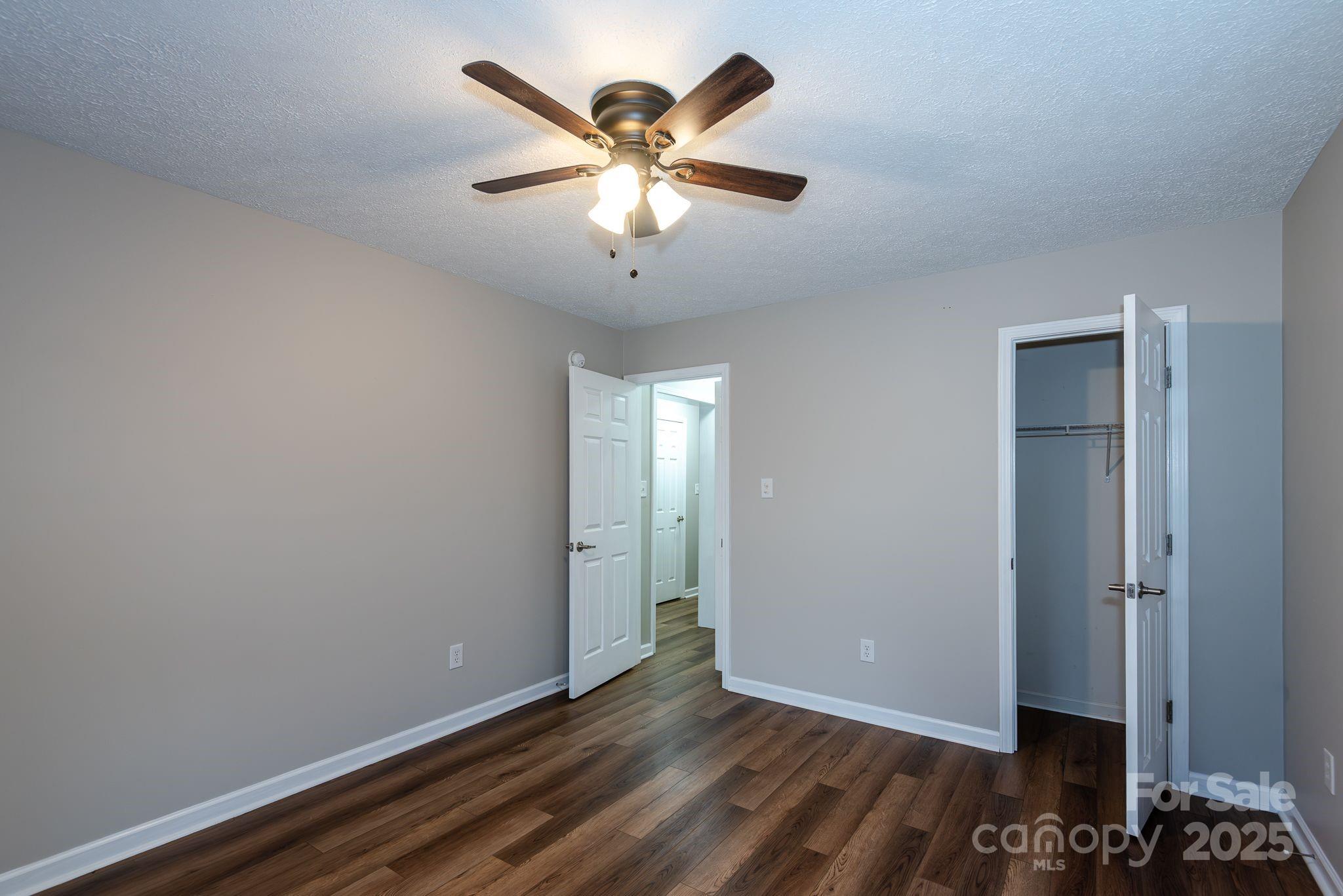 263 Newberry Drive Fletcher, NC 28732 - Photo 24 of 29 an empty room with closet and wooden floor