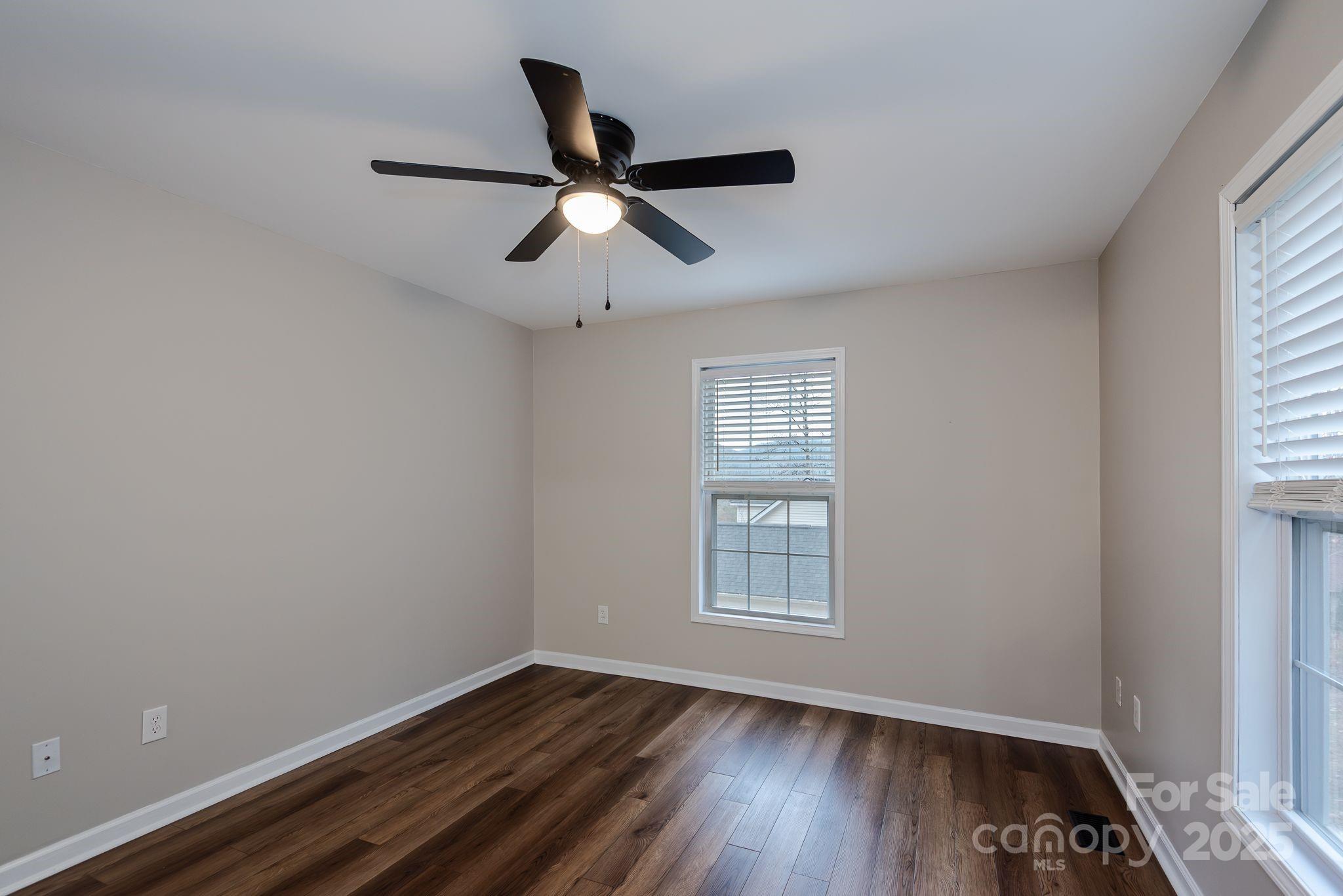 263 Newberry Drive Fletcher, NC 28732 - Photo 25 of 29 a view of empty room with wooden floor and fan
