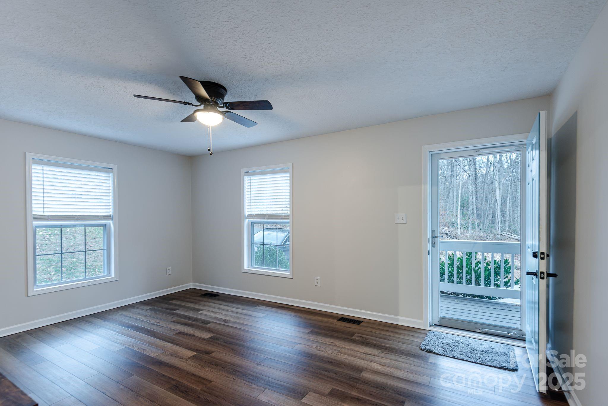 263 Newberry Drive Fletcher, NC 28732 - Photo 6 of 29 a view of an empty room with wooden floor and a window